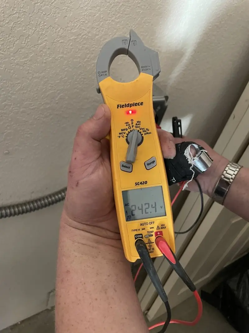 Voltage testing with clamp meter during Ceiling Fan Installation in Bell